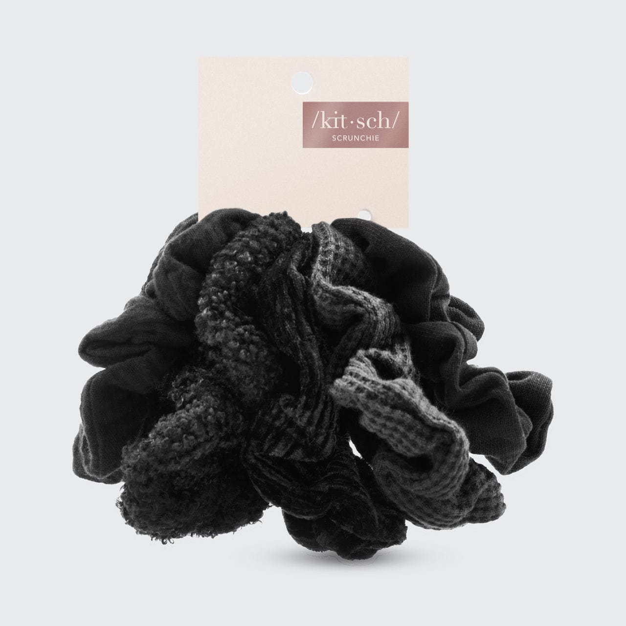 KITSCH Assorted Textured Scrunchies in Black — product packaging shot — 5 assorted textured black scrunchies — mixed textures for versatile styling