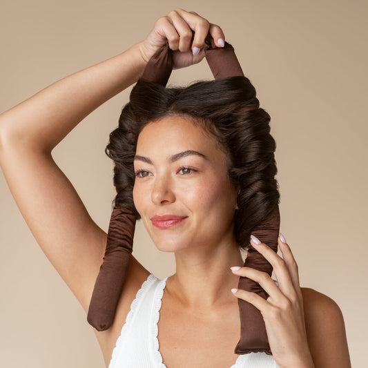 Model wearing the Chocolate XL Satin Heatless Curling Set to create curls without heat.