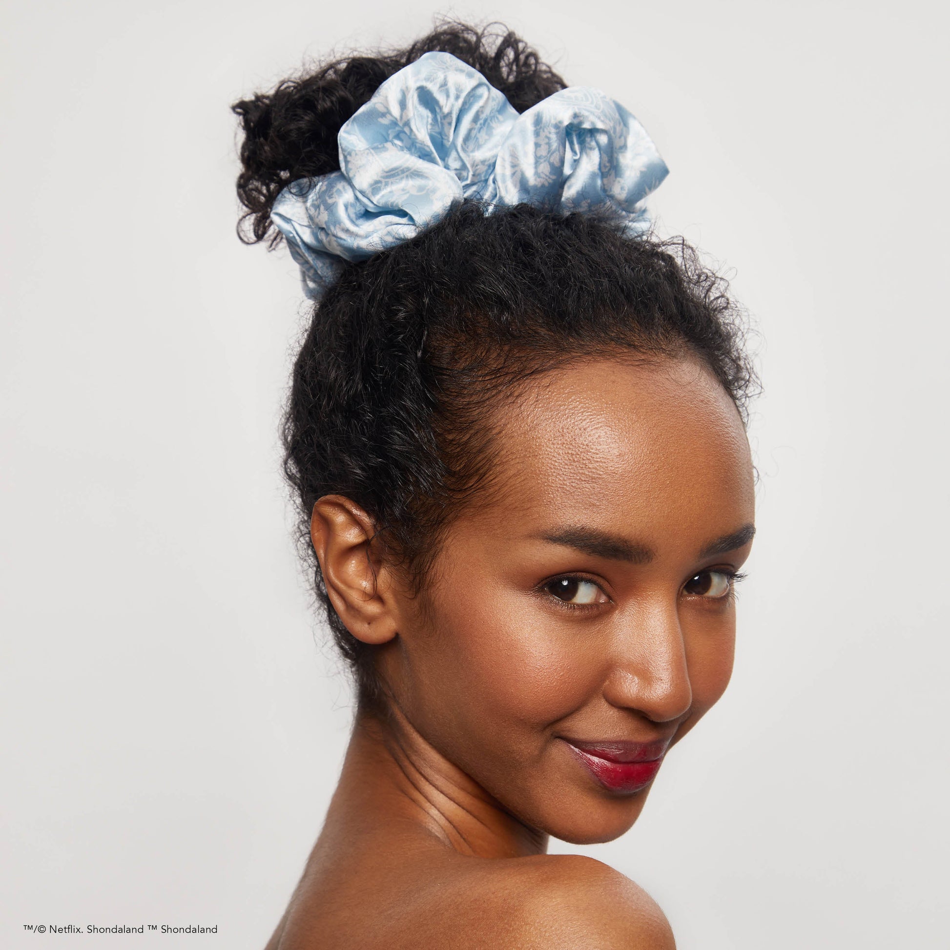 KITSCH Kitsch x Bridgerton Satin Pillow Scrunchies in Toile De Blue — model wearing scrunchie — Bridgerton-inspired Toile De Blue print on silky satin — pillow-soft, won't crimp hair overnight