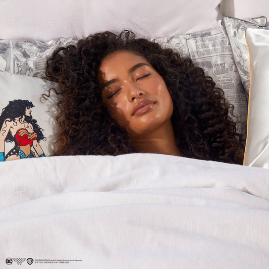 Model sleeping on Kitsch x Wonder Woman Comic Print Standard Satin Pillowcase