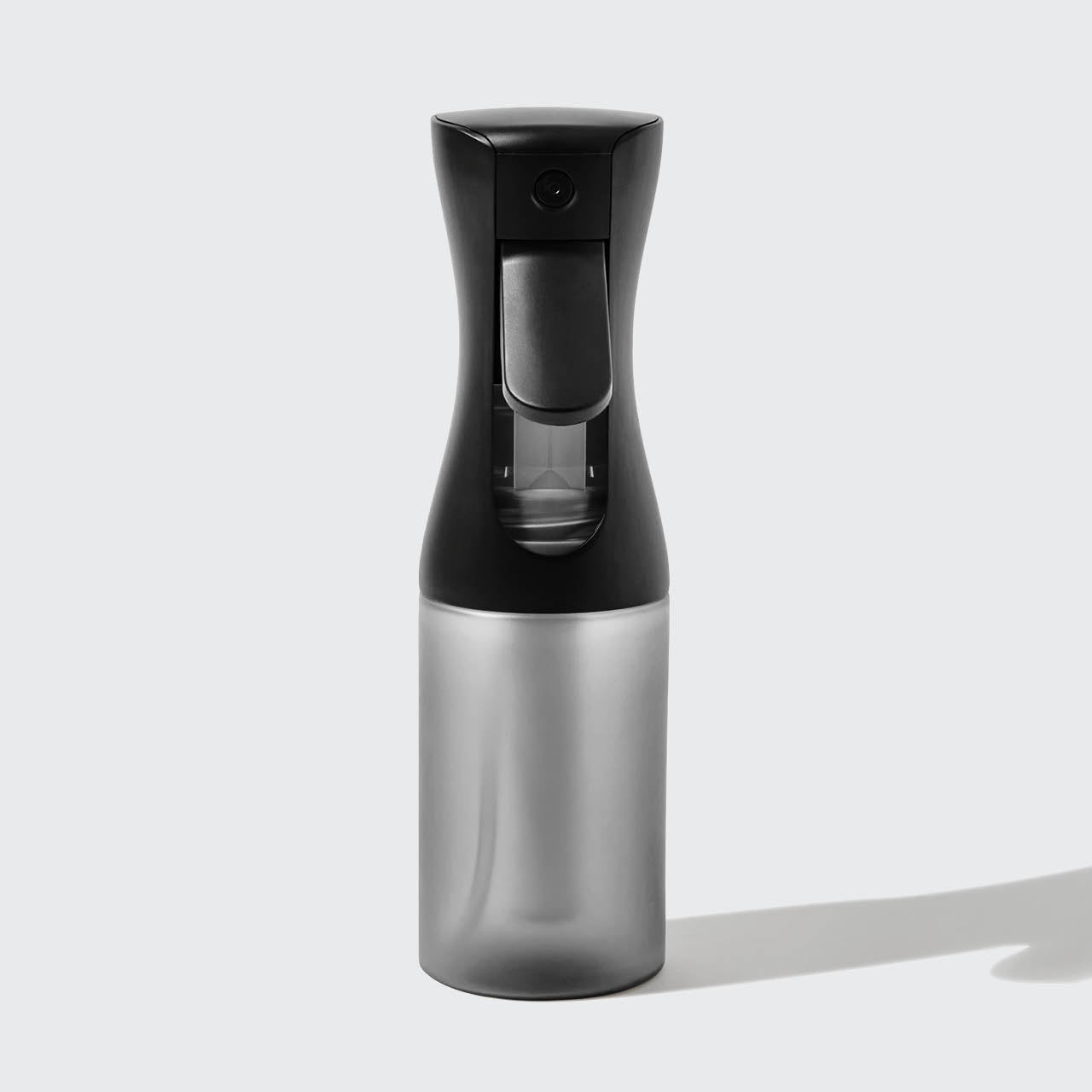 Model using Black Continuous Spray to mist hair showing fine mist output