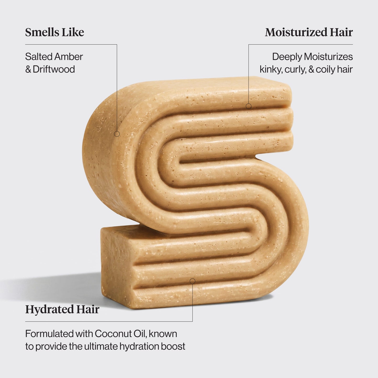 A beige, textured hair shampoo bar shaped like a stylized letter 'S' on a light gray background, with text callouts describing its scent and hair benefits.