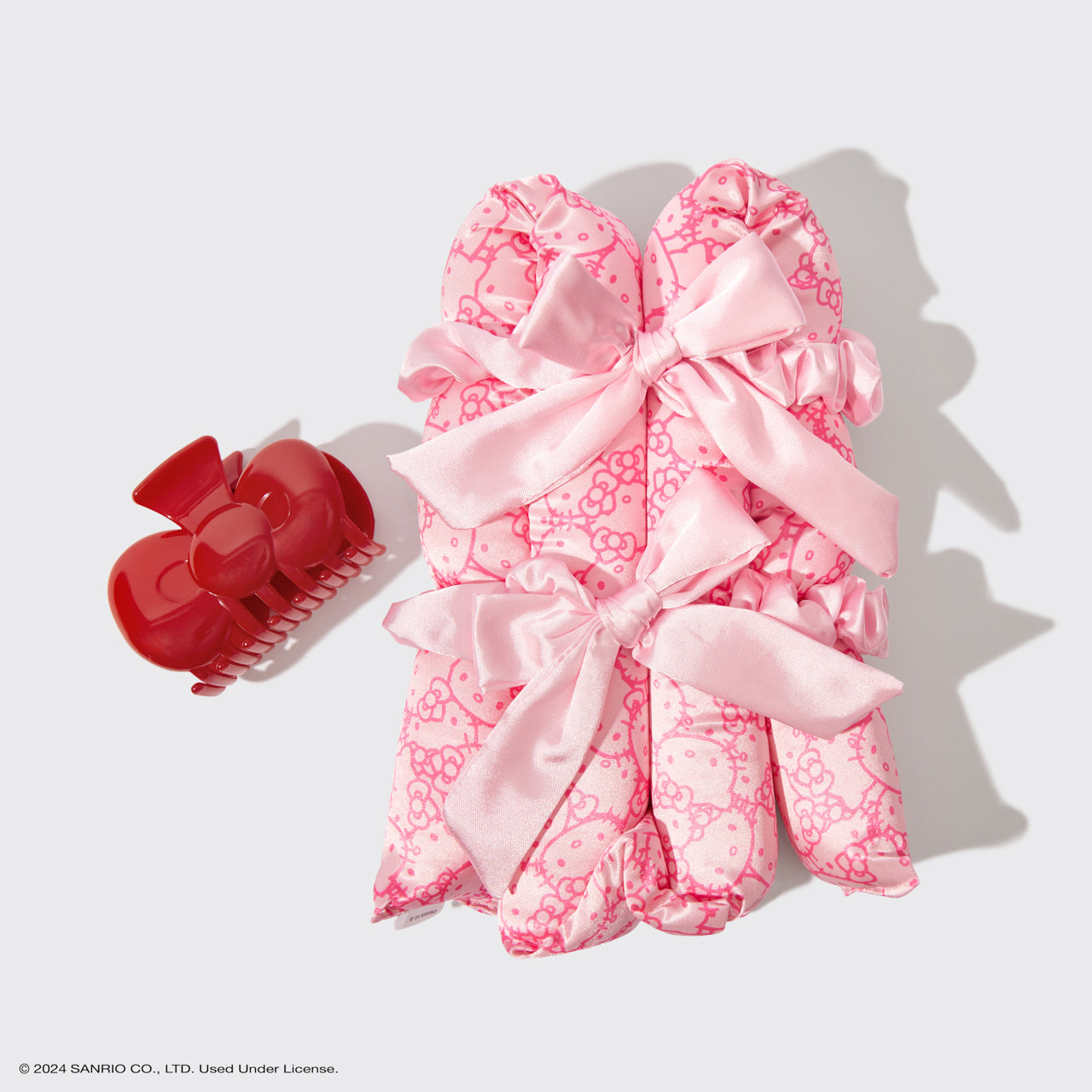 KITSCH Hello Kitty x KITSCH XL Satin Heatless Styling & Bow Claw Clip 4pc Set — flat lay — all 4 pieces displayed: XL satin curling rod, bow claw clip and 2 scrunchies in Hello Kitty print