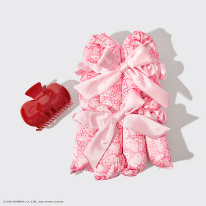 KITSCH Hello Kitty x KITSCH XL Satin Heatless Styling & Bow Claw Clip 4pc Set — flat lay — all 4 pieces displayed: XL satin curling rod, bow claw clip and 2 scrunchies in Hello Kitty print