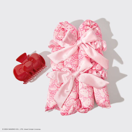KITSCH Hello Kitty x KITSCH XL Satin Heatless Styling & Bow Claw Clip 4pc Set — flat lay — all 4 pieces displayed: XL satin curling rod, bow claw clip and 2 scrunchies in Hello Kitty print