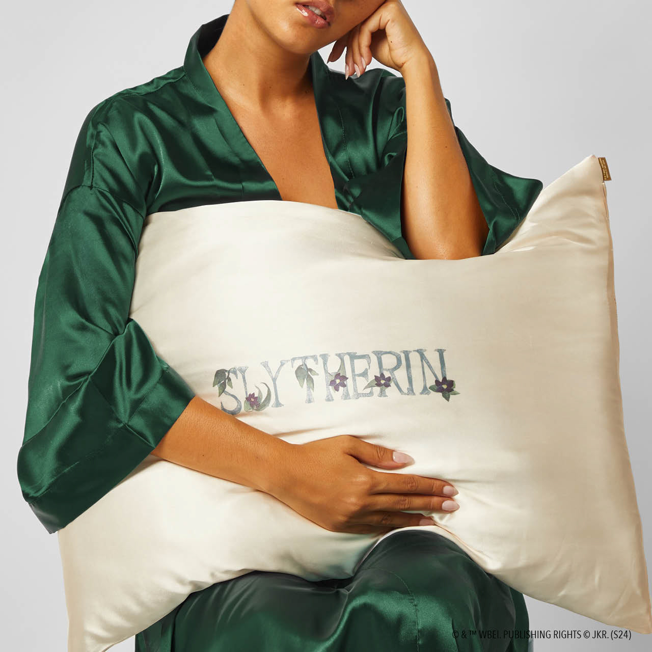 Model sleeping on Kitsch x Harry Potter Slytherin Standard Satin Pillowcase