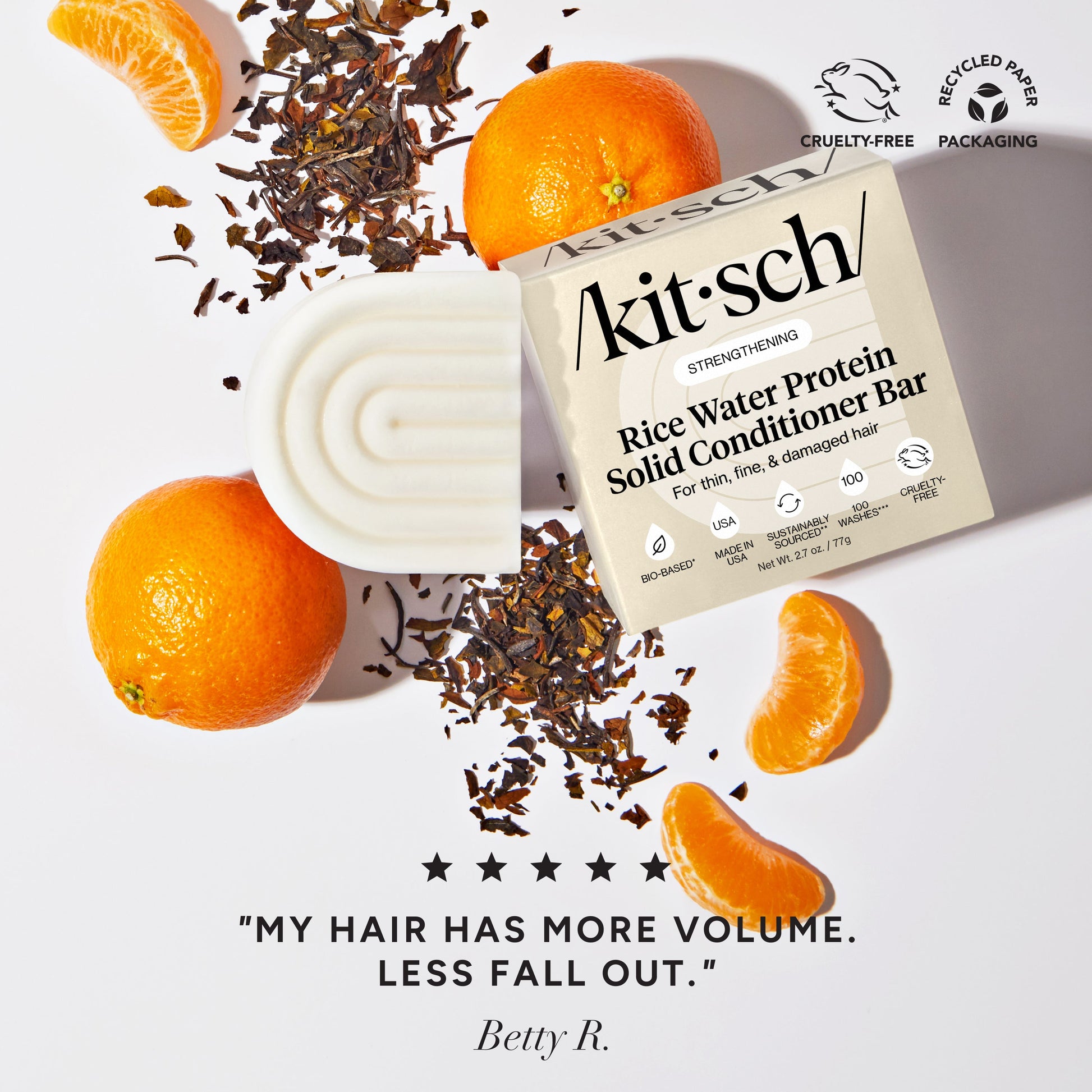 Kitsch Rice Water Conditioner Bar styled with oranges and tea leaves with customer review my hair has more volume less fall out - bio-based solid conditioner bar with Rice Tein NPNF clinically proven to increase hair volume by 20% after 5 washes. For thin, fine, and damaged hair. Cruelty-free, recycled paper packaging, made in USA, 100 washes, 3.2 oz / 91g.