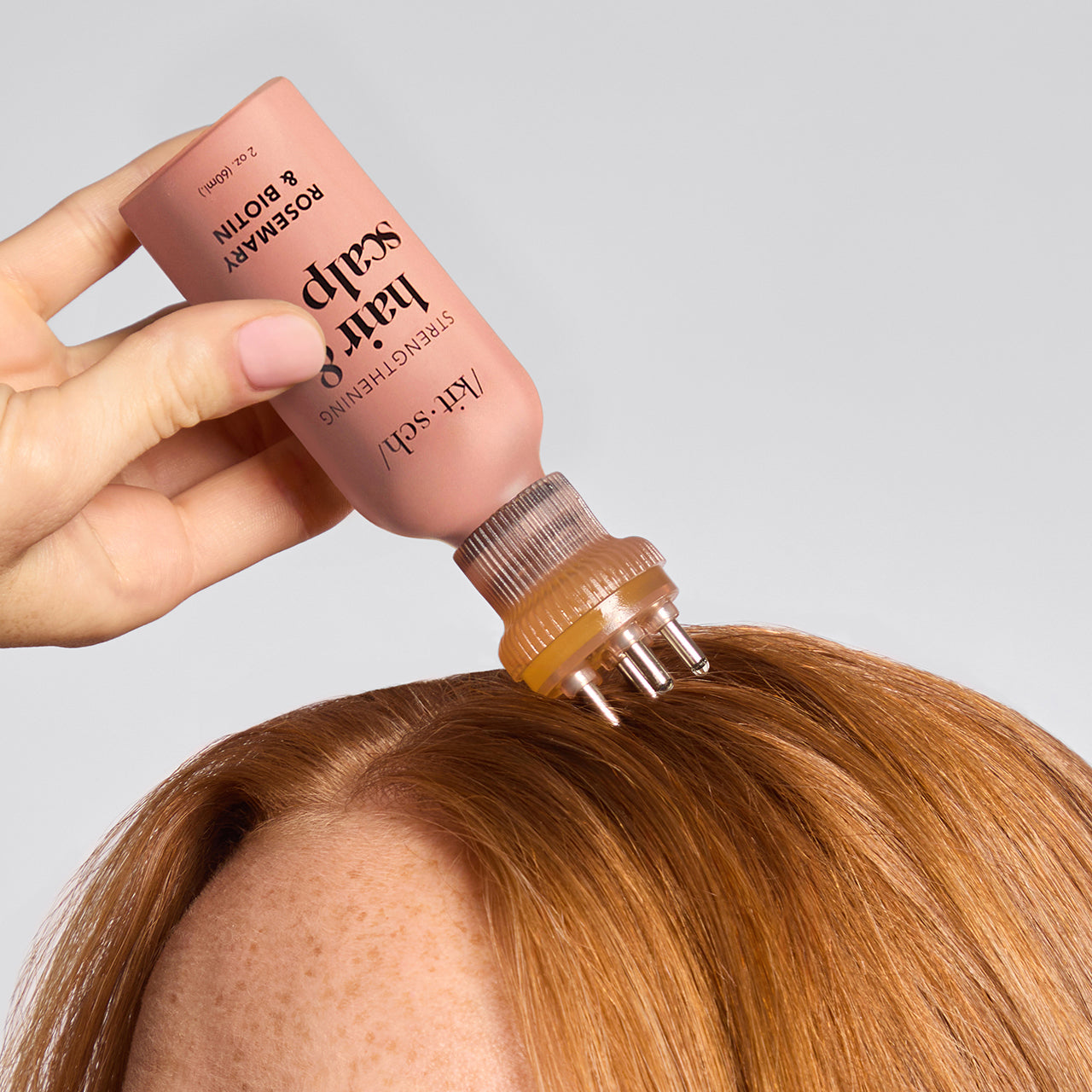 KITSCH Scalp & Hair Oil Applicator in terracotta — lifestyle shot — model applying scalp oil