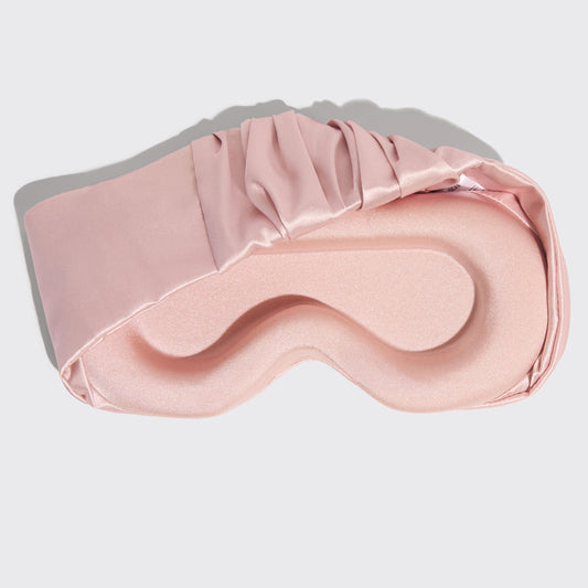 Model wearing Blush Contour Pillow Eye Mask showing relaxed fit over eyes