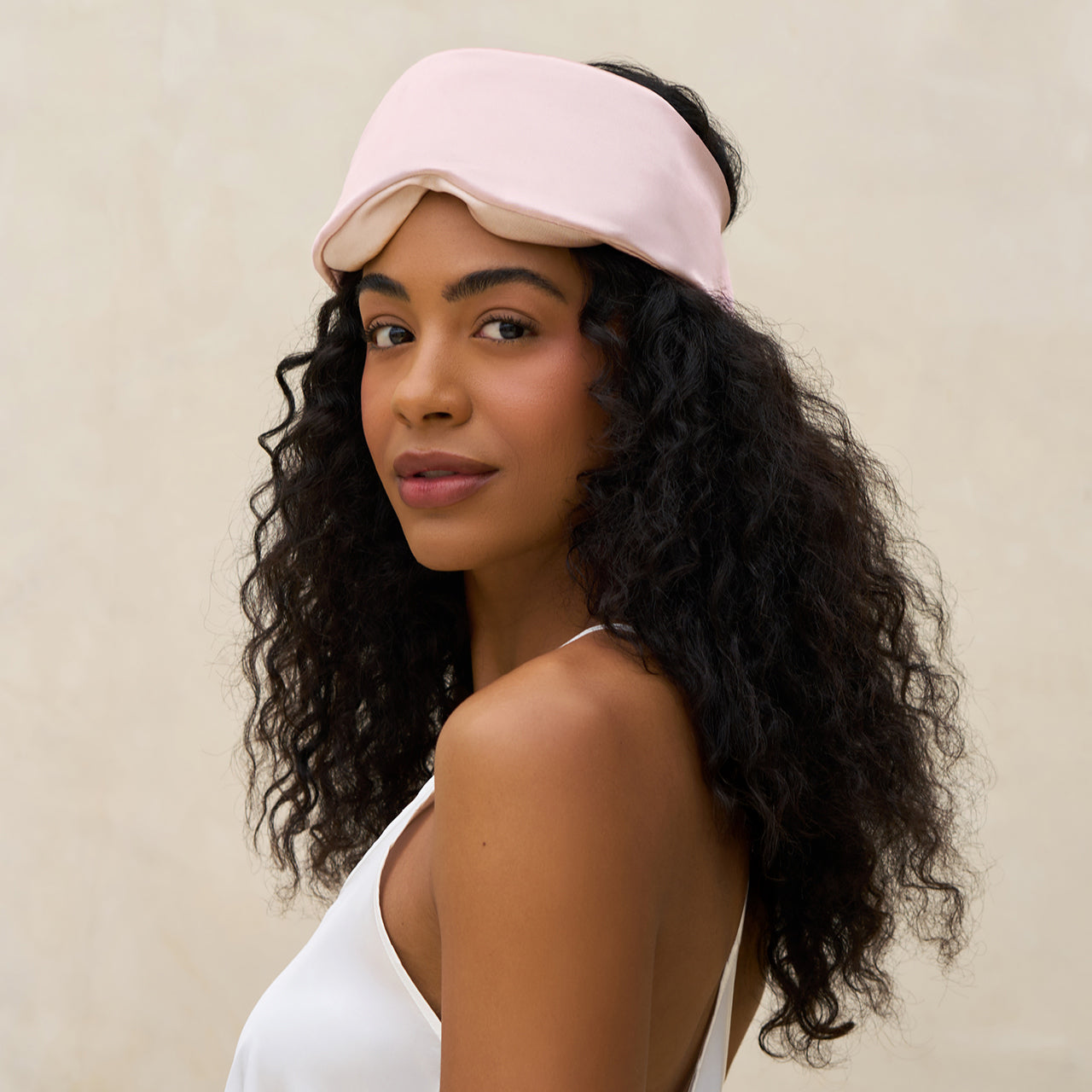Close-up of blush satin fabric and padded contour shape