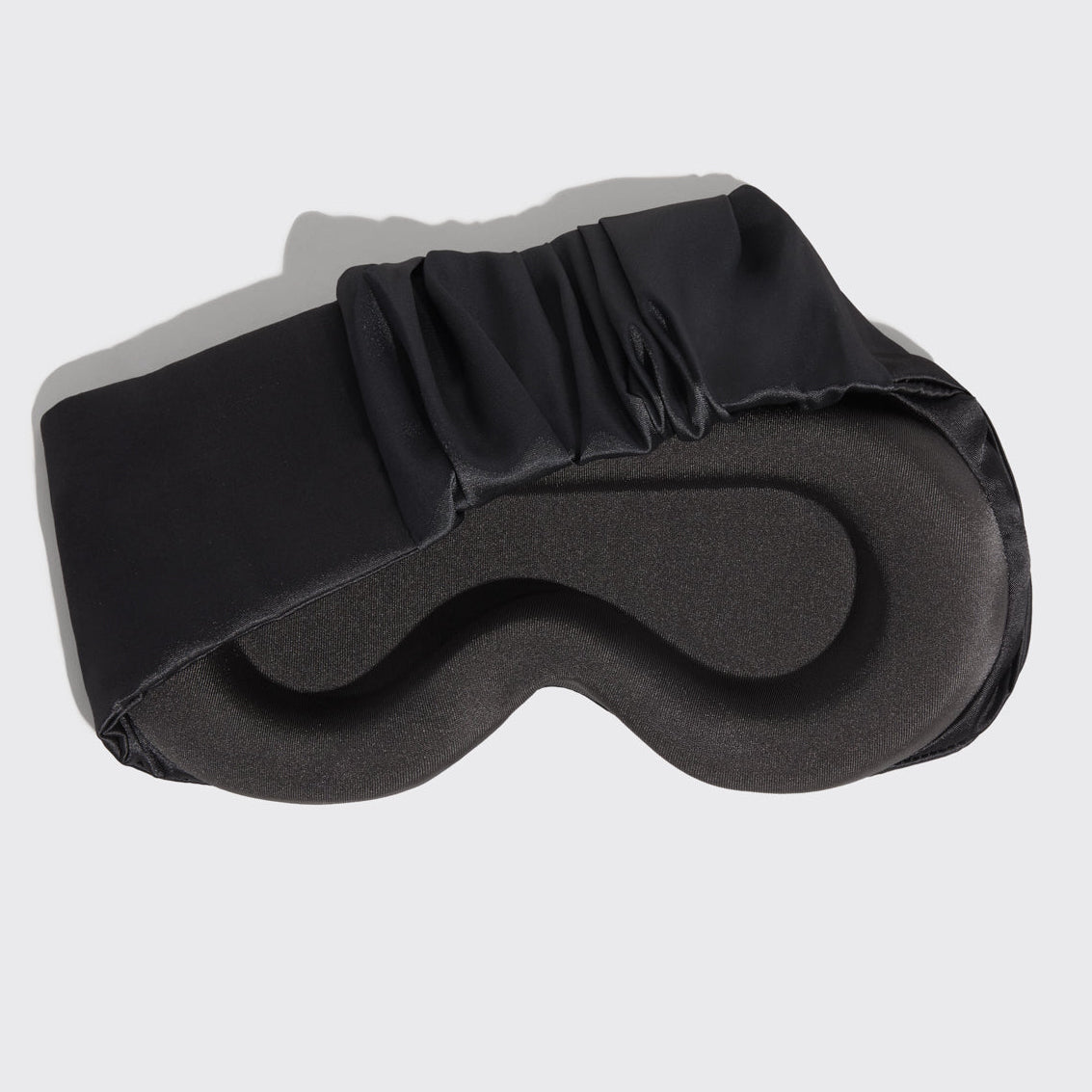 Model wearing Charcoal Contour Pillow Eye Mask showing relaxed fit over eyes