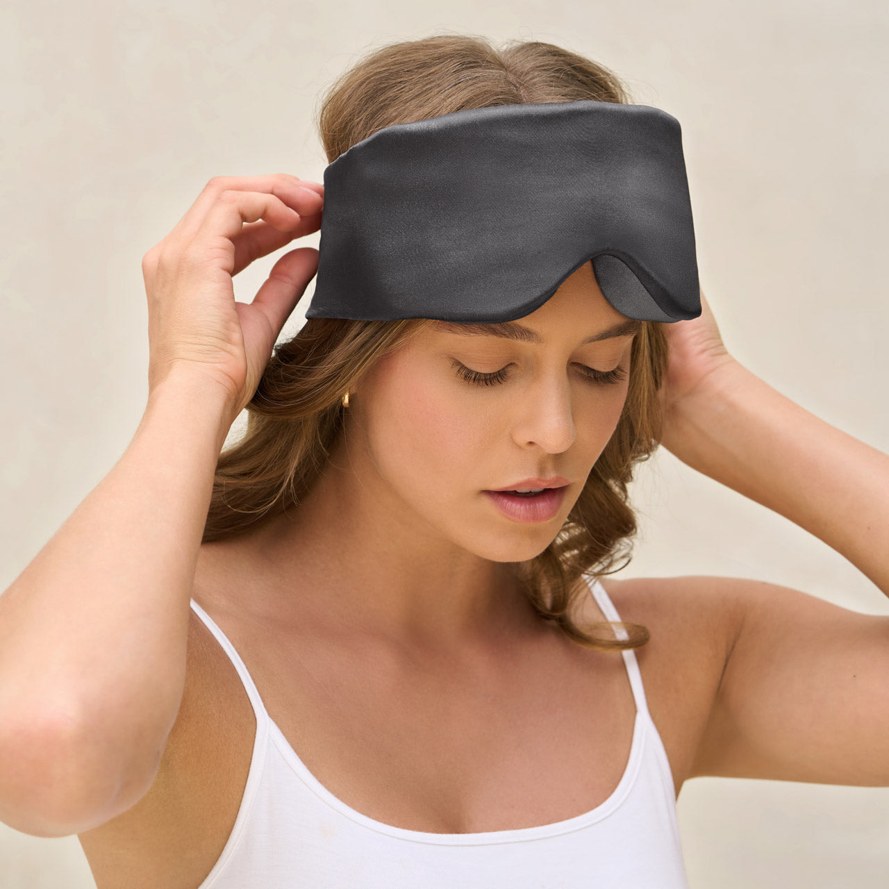 Close-up of charcoal satin fabric and padded contour shape