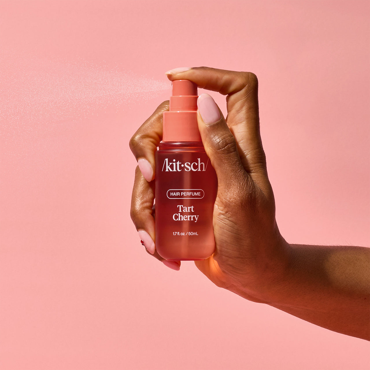 Close-up of the Kitsch Tart Cherry Hair Perfume spray nozzle and rose-gold detail