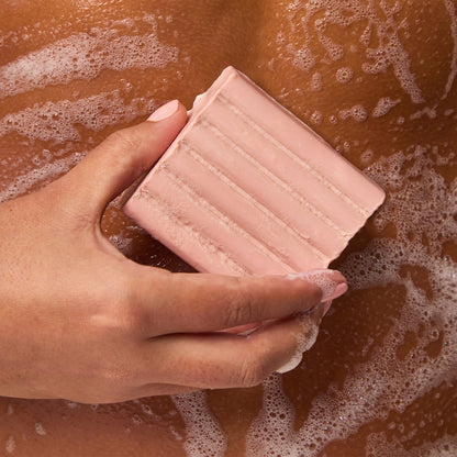KITSCH Cleansing Tart Cherry Solid Body Wash — model using body wash bar — Sudsy lather for a soft, luxurious cleanse — sustainable and travel-friendly—no plastic, no spills, just a compact bar that lasts