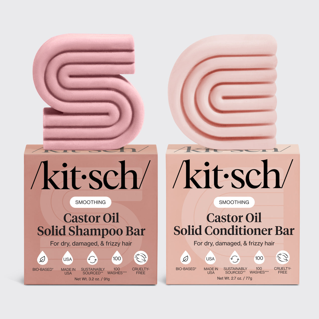 KITSCH Castor Oil Solid Shampoo Bar + Solid Conditioner Bar combo product lineup on light gray background — SMOOTHING Castor Oil Shampoo Bar (3.2 oz) and Conditioner Bar (2.7 oz) bars with retail boxes — For dry, damaged, & frizzy hair — Bio-based | Made in USA | Sustainably Sourced | 100 Washes | Cruelty-FreeTwo pink kitsch castor oil shampoo and conditioner bars with their respective boxes on a light gray background