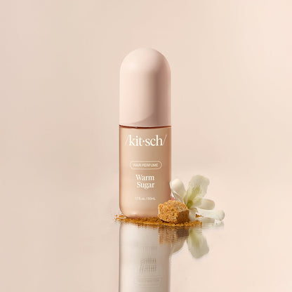 Close-up of Kitsch Warm Sugar Hair Perfume bottle showing the rose-gold spray cap