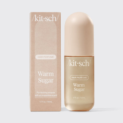 Kitsch Warm Sugar Hair & Body Perfume Mist bottle on a soft pink background