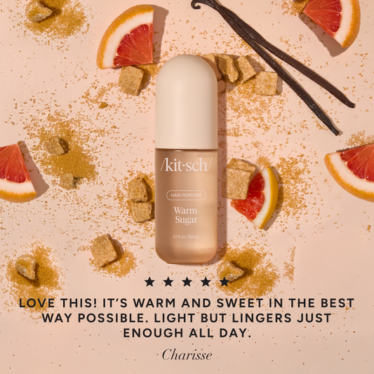Kitsch Warm Sugar Hair Perfume bottle with 5-star customer review, surrounded by grapefruit and vanilla on a pink background