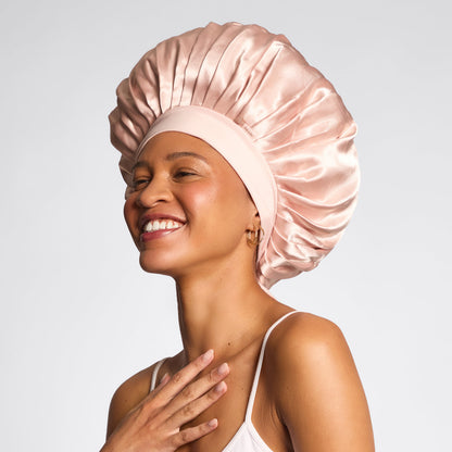 KITSCH Blush Oversized Satin Bonnet — model lifestyle shot — worn while sleeping