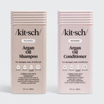 KITSCH Repairing Argan Oil Shampoo 12 fl. oz. & Conditioner 12 fl. oz. Combo — both labeled REPAIRING, For damaged, weak, & brittle hair — icons: Bio-Based, Nontoxic, Sustainably Sourced, Cruelty-Free — Shampoo formulated with Terabond™ & Hydrolyzed Oat Protein; Conditioner formulated with Fision® EcoSil & PhytoVie® Defense
