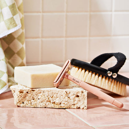 KITSCH Safety Razor & Shave Butter Bundle — model lifestyle shot — smooth shaving with silver safety razor on leg — less irritation, fewer ingrown hairs