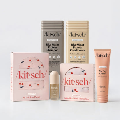 KITSCH Ultimate Shower Bundle — hero flat lay — Rice Water Protein Shampoo + Conditioner + Warm Sugar Hair Perfume + Air Dry Cream + Cherry Print Shower Cap + XL Hair Towel — complete shower upgrade