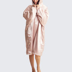 Model wearing the Kitsch Glazey in Blush, a satin hooded robe designed for cozy comfort and overnight hair protection.