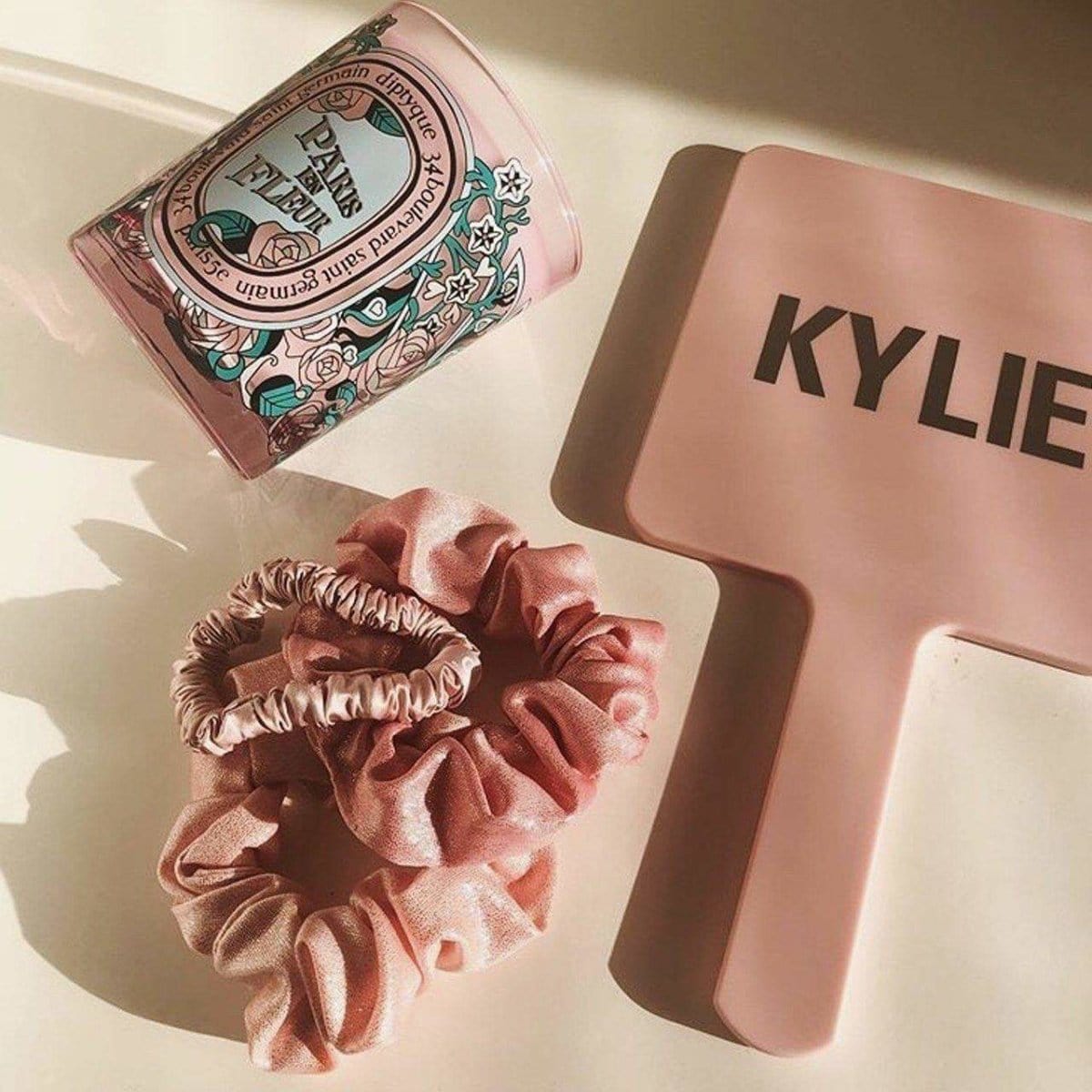 KITSCH Satin Sleep Scrunchies in Blush — lifestyle product shot of blush pink satin sleep scrunchies — silky construction prevents creasing and breakage overnight