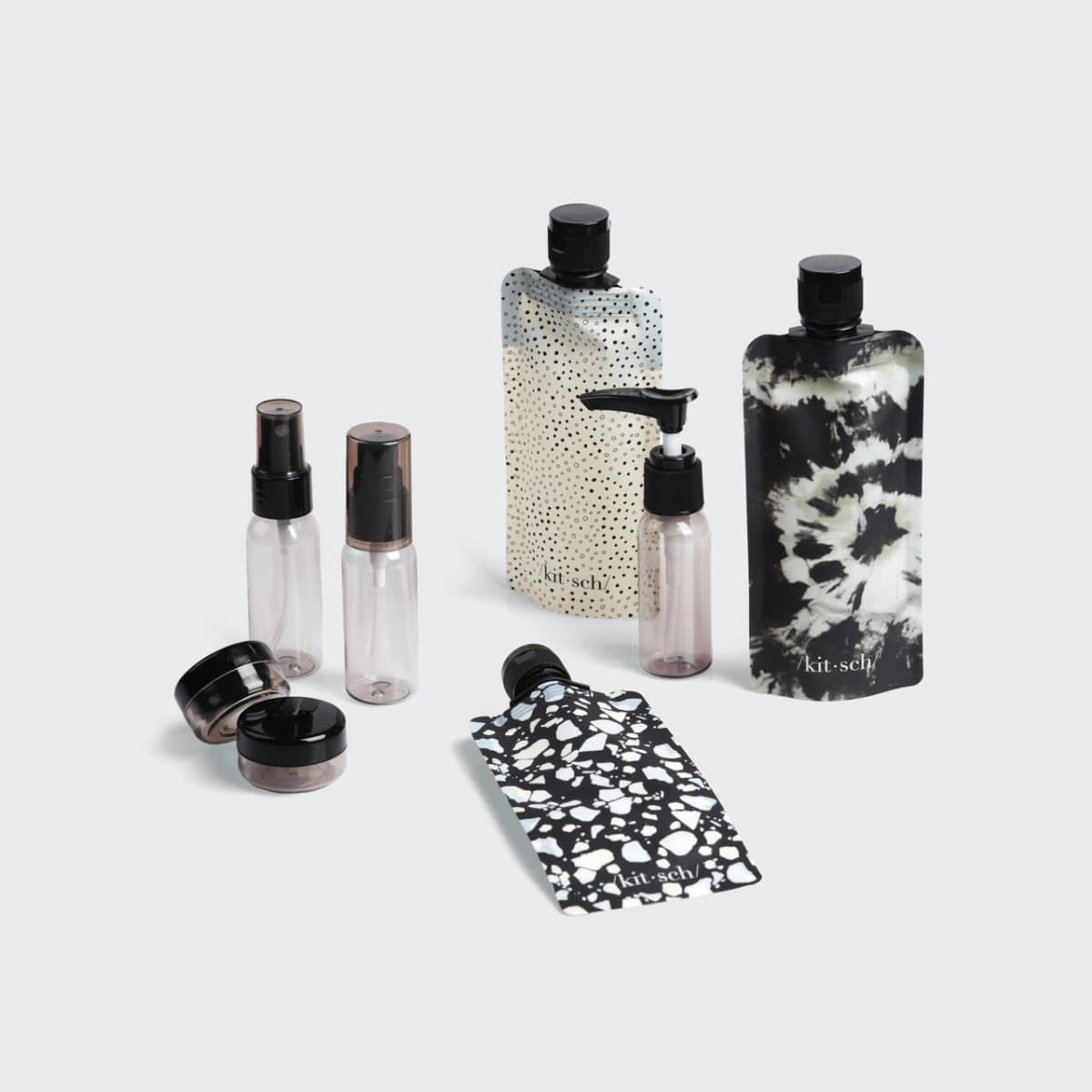 Kitsch Black & Ivory Travel Bottles 11pc Set flat lay with toiletry contents shown